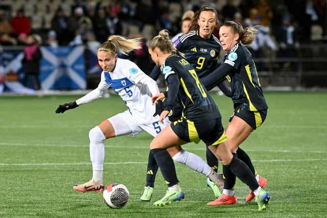 Emma Koivisto (L) of Finland vies with Samantha Kerr, Caroline Weir and Kirsty Hanson of Scotland. Cr: AP.