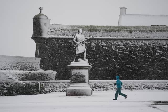 A person runs in the snow at Stirling Castle during Storm Bert late last month. Picture: PA