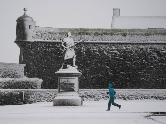 A person runs in the snow at Stirling Castle during Storm Bert late last month. Picture: PA