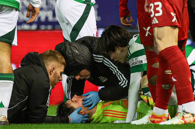 Aberdeen physios and Celtic's Kyogo Furuhashi check on an injured Ross Doohan. (Photo by Craig Williamson / SNS Group)