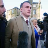   Former Scotland rugby captain Stuart Hogg (centre) leaves Jedburgh Sheriff Court after being sentenced to a five-year non-harassment order and fined after breaching bail  