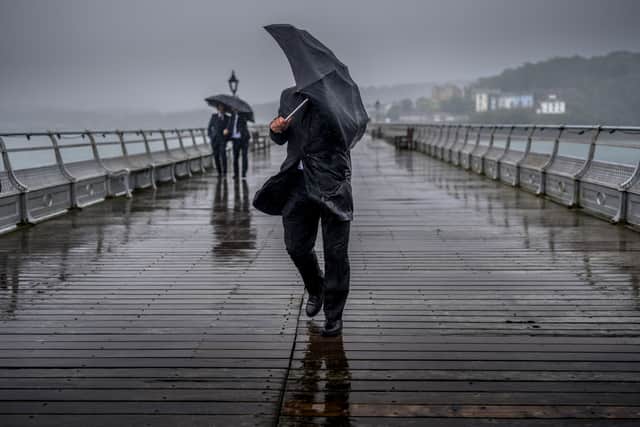 People battle against high winds and driving rain. An amber alert has been issued with Storm Darragh set to hit the UK. Picture: Christopher Furlong/Getty Images