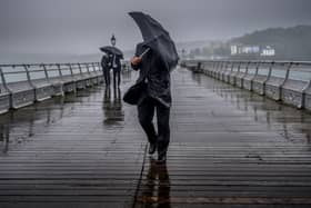 People battle against high winds and driving rain. An amber alert has been issued with Storm Darragh set to hit the UK. Picture: Christopher Furlong/Getty Images