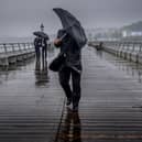 People battle against high winds and driving rain. An amber alert has been issued with Storm Darragh set to hit the UK. Picture: Christopher Furlong/Getty Images