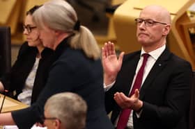 John Swinney applauds as Finance Secretary Shona Robison delivers her Budget on Wednesday (Picture: Jeff J Mitchell)