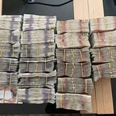 Photo issued by National Crime Agency of bundles of cash seized