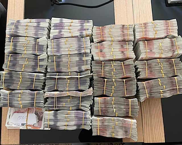Photo issued by National Crime Agency of bundles of cash seized