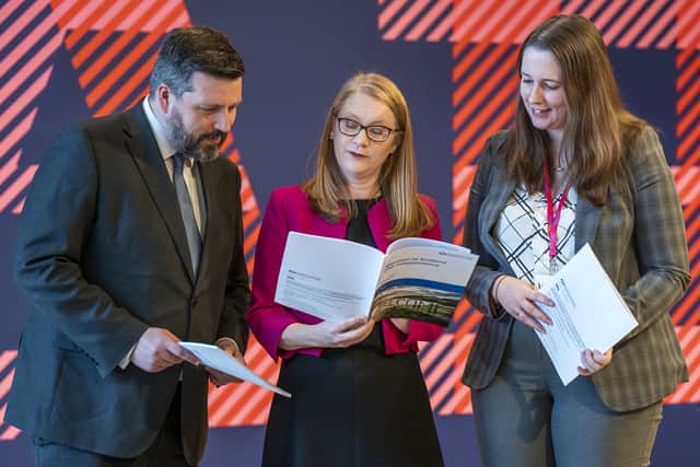 Former independence minister Jamie Hepburn, Social Justice Secretary Shirley-Anne Somerville and former refugees minister Emma Roddick with one of the previous independence papers.