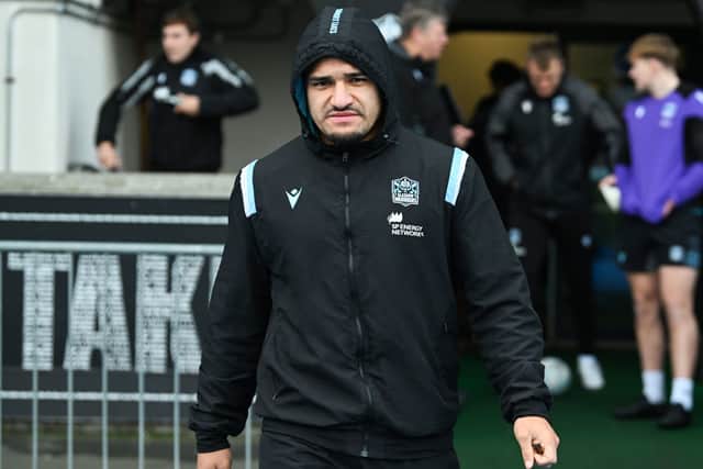 Sione Tuipulotu wraps up warm ahead of Glasgow Warriors' opener against Sale.
