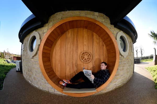 AirB&B host Mike Afflick reads his Lancashire Post while taking a break at his Hobbit House in Inglewhite, near Preston. 