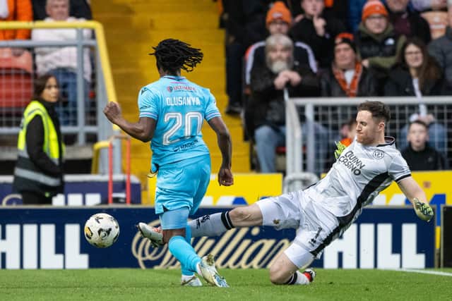 Dundee United's Jack Walton challenges Toyosi Olusanya which was subsequently looked at by VAR. (Photo by Paul Devlin / SNS Group)