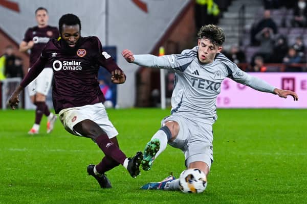 Aberdeen's Jack Milne fouls Hearts' Beni Baningime leading to a VAR check for a possible red card. (Photo by Rob Casey / SNS Group)