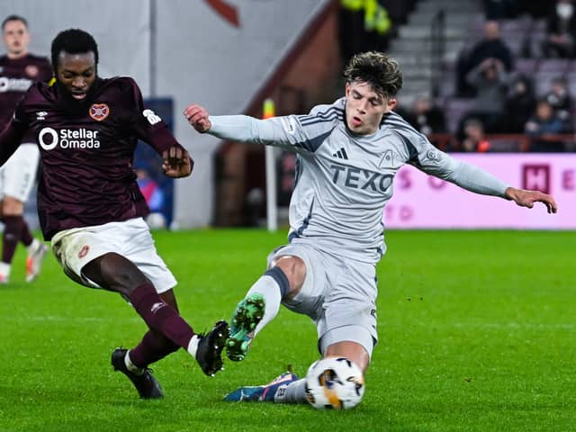Aberdeen's Jack Milne fouls Hearts' Beni Baningime leading to a VAR check for a possible red card. (Photo by Rob Casey / SNS Group)