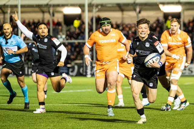 Glasgow Warriors' George Horne powers through to score his first try of the night against Sale Sharks.