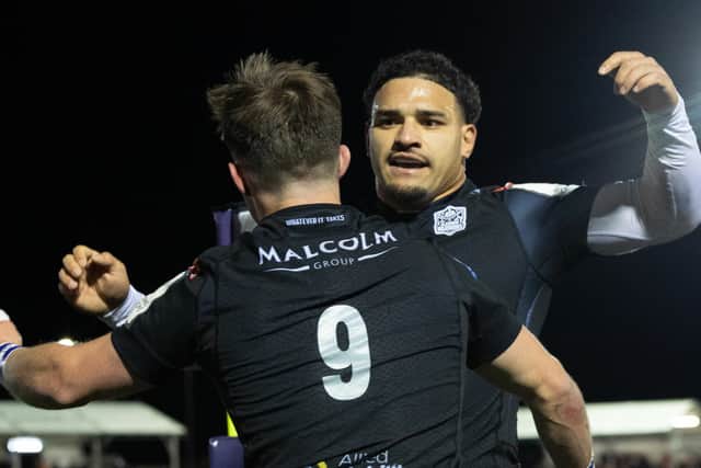 Sione Tuipulotu congratulates George Horne on the second try of his first-half hat-trick.