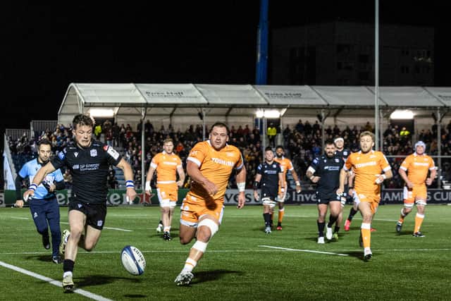 George Horne aims a delicate kick down the line on the way to scoring the second try of his hat-trick for Glasgow Warriors against Sale Sharks.