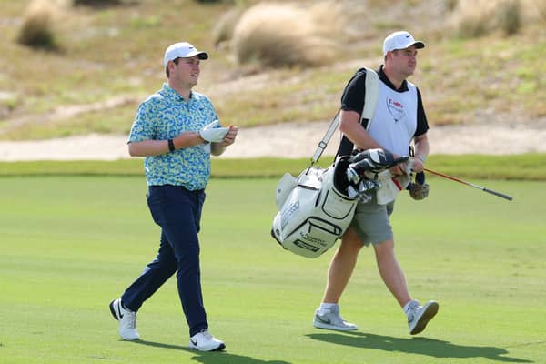 Bob MacIntyre walks with caddie Mike Burrow during the final round of the Hero World Challenge in the Bahamas