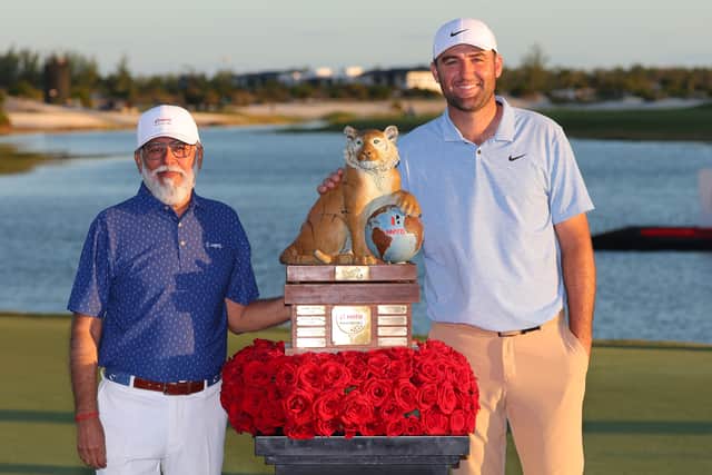 Scottie Scheffler with the trophy and Dr. Pawan Munjal, Executive Chairman of Hero MotoCorp, after winning the Hero World Challenge at Albany Golf Course