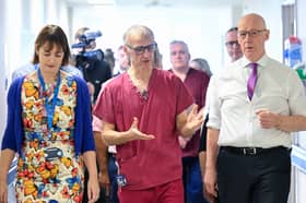 Under John Swinney, seen visiting Forth Valley Hospital last week, Scotland is continuing to pay more in tax in return for poorer services (Picture: Lesley Martin/pool)