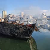 Smoke billows from a Syrian naval ship destroyed in an overnight Israeli attack on the port city of Latakia