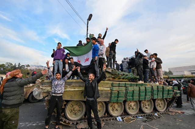 People celebrate in Umayyad Square, Damascus, after the fall of the Assad regime (Picture: Louai Beshara)