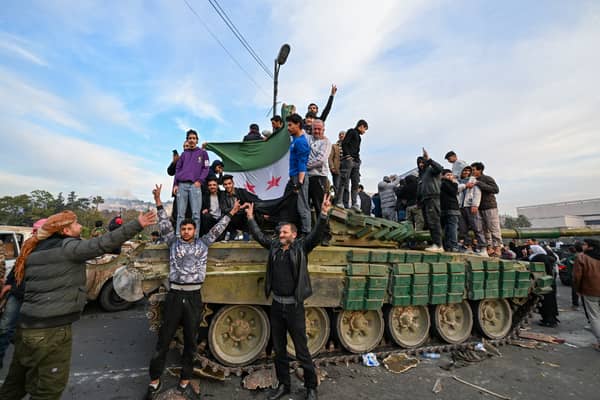 People celebrate in Umayyad Square, Damascus, after the fall of the Assad regime (Picture: Louai Beshara)