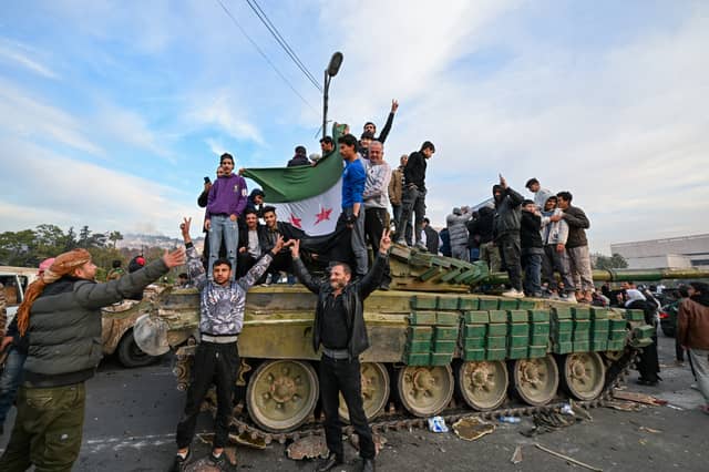 People celebrate in Umayyad Square, Damascus, after the fall of the Assad regime (Picture: Louai Beshara)