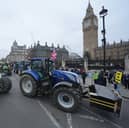 Tractors are lined up outside the Houses of Parliament in Westminster, London, during a protest by farmers over the changes to inheritance tax