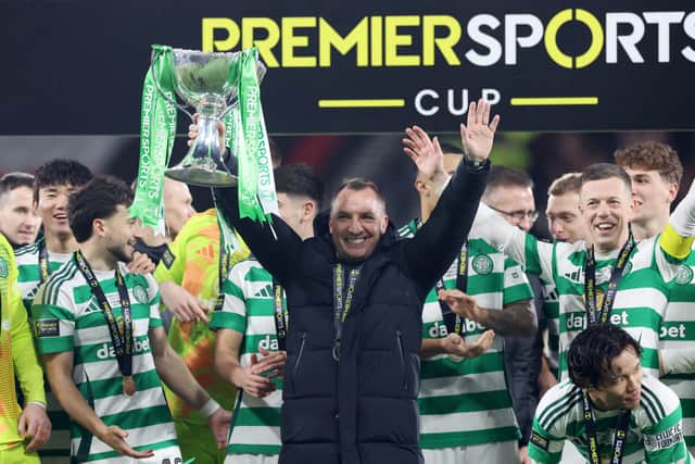 Brendan Rodgers, manager of Celtic, celebrates with the Premier Sports Cup trophy.