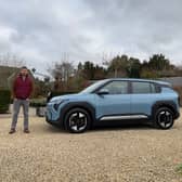 Scotsman author Steven Chisholm with the Kia EV3 Air in Frost Blue paint, in the Cotswolds