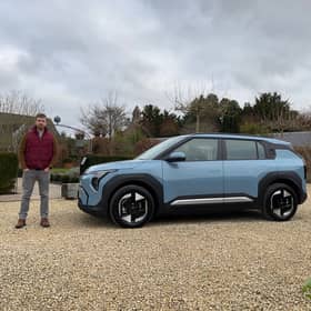 Scotsman author Steven Chisholm with the Kia EV3 Air in Frost Blue paint, in the Cotswolds
