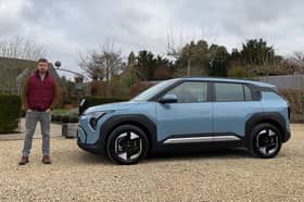 Scotsman author Steven Chisholm with the Kia EV3 Air in Frost Blue paint, in the Cotswolds