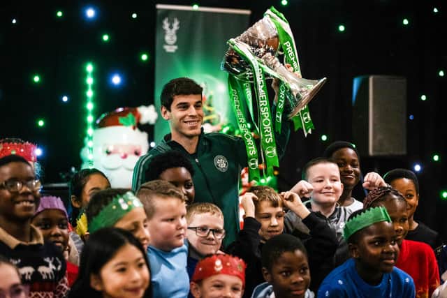 Celtic's Paulo Bernardo with the Premier Sports Cup trophy during a Celtic FC Foundation Schools Party at Celtic Park with local Primary 5 pupils from four East End schools - Dalmarnock, Riverbank, Sacred Heart and St Timothy. (Photo by Craig Williamson / SNS Group)