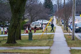 Students from Abundant Life Christian School in Madison, Wisconsin, are escorted to a city bus where they will be reunited with their parents after a school shooting.