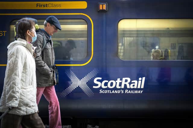 Commuters walking past a ScotRail train at Edinburgh's Waverley Station