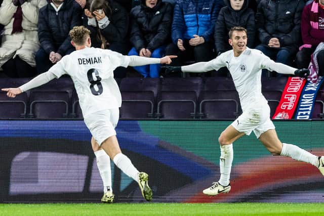 Petrocub's Sergiu Platica (R) celebrates scoring to make it 1-0 over Hearts at Tynecastle. (Photo by Ross Parker / SNS Group)