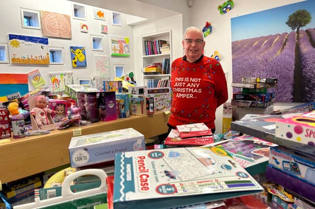 Prison officer Colin O’Flaherty surrounded by donated presents at HMP Edinburgh