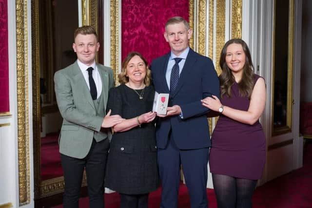 Stephen Gallacher shows off his MBE flanked by wife Helem son Jack and daughter Ellie at Buckingham Palace