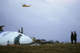 Officials inspect the wreckage of Pan Am flight 103 on December 21, 1988, in Lockerbie