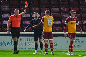 Motherwell's Dan Casey is shown a red card by referee Chris Graham. (Photo by Rob Casey / SNS Group)