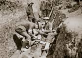 Medics tend to a wounded man during the Battle of the Somme, France, 1916