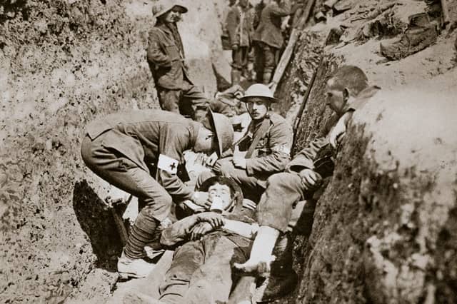 Medics tend to a wounded man during the Battle of the Somme, France, 1916