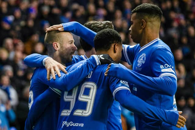 Rangers' Vaclav Cerny (L) celebrates scoring to make it 1-0 with teammtes Danilo (C) and Hamza Igamane.