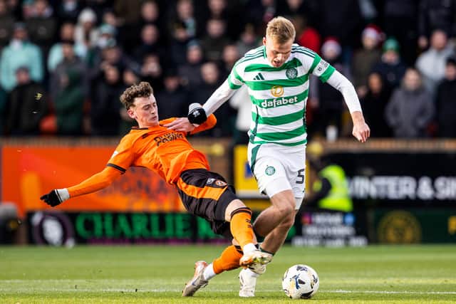 Stephen Welsh, making his second appearance of the season for Celtic, is tackled by Dundee United's Miller Thomson.  (Photo by Alan Harvey / SNS Group)