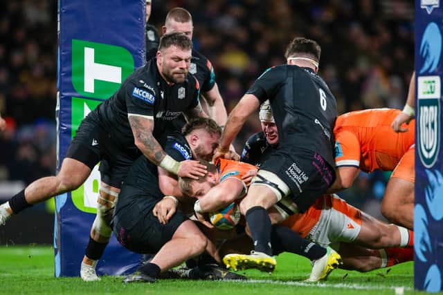 Edinburgh's Boan Venter, partially hidden, plunges over for the first of his two tries in the defeat by Glasgow Warriors at Hampden.