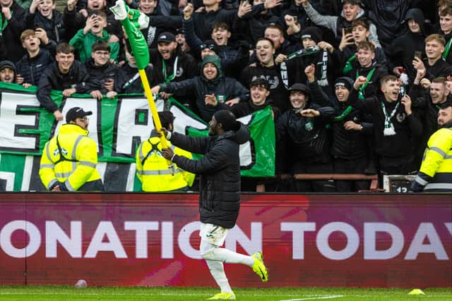 Elie Youan celebrates with the away fans after the win.