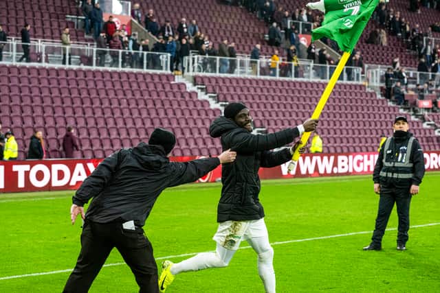 Elie Youan cavorts with the corner flag after Hibs' win.