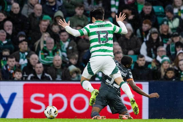 Motherwell's Tawanda Maswanhise was booked for simulation after going down under a challenge from Celtic's Hyun-jun Yang. (Photo by Craig Foy / SNS Group)