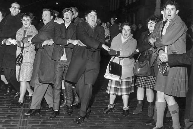 People singing Auld Lang's Syne during New Year at the Tron, Edinburgh 1964. The Scots have long regarded Hogmanay as the festive celebration of choice.