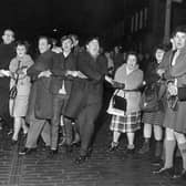 People singing Auld Lang's Syne during New Year at the Tron, Edinburgh 1964. The Scots have long regarded Hogmanay as the festive celebration of choice. 